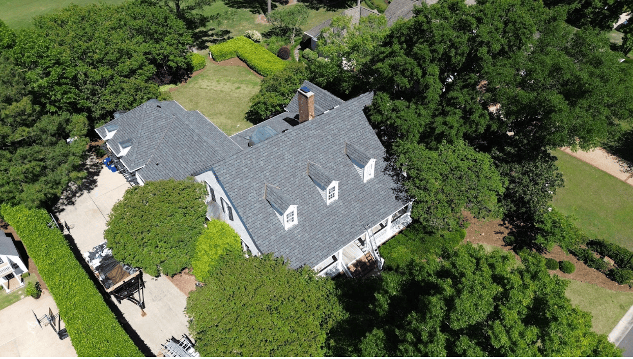 Aerial view of a house with grey shingle roof
