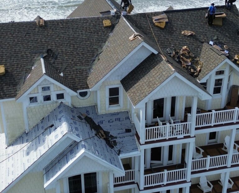 Summit Roofing team working on the roof of a large house