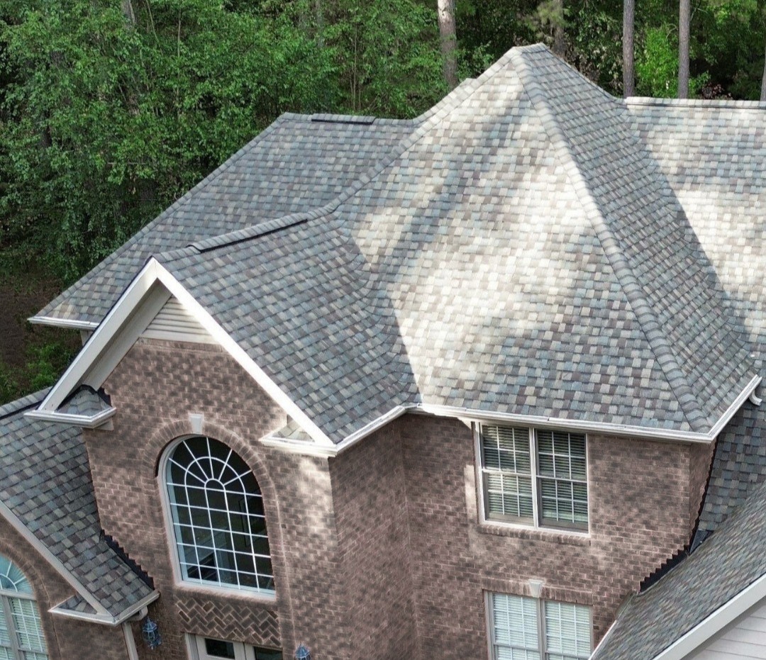 a brick house with a shingle roof