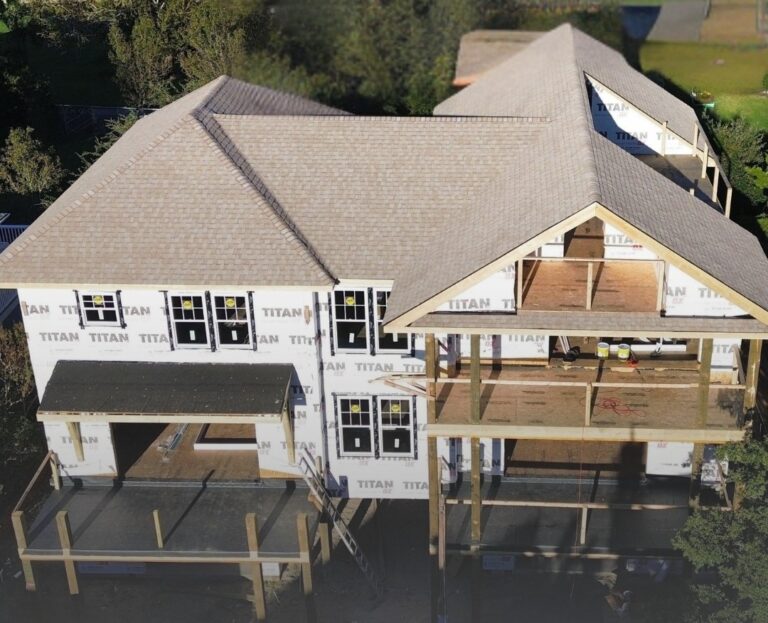 a new house being built, shingle roof installed