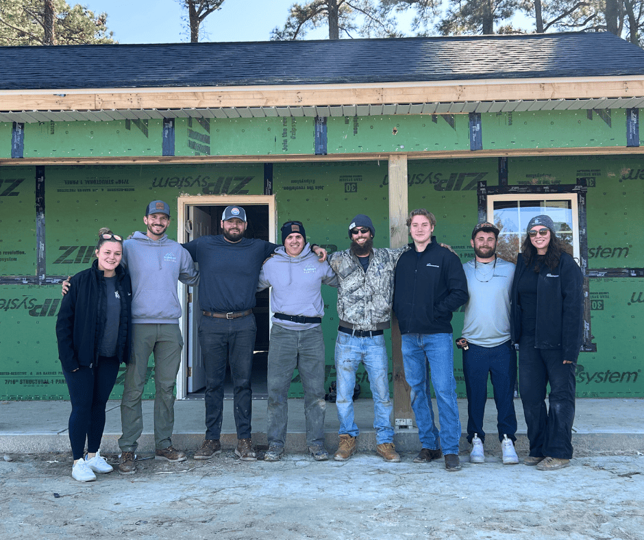 Summit Roofing Team in front of a house