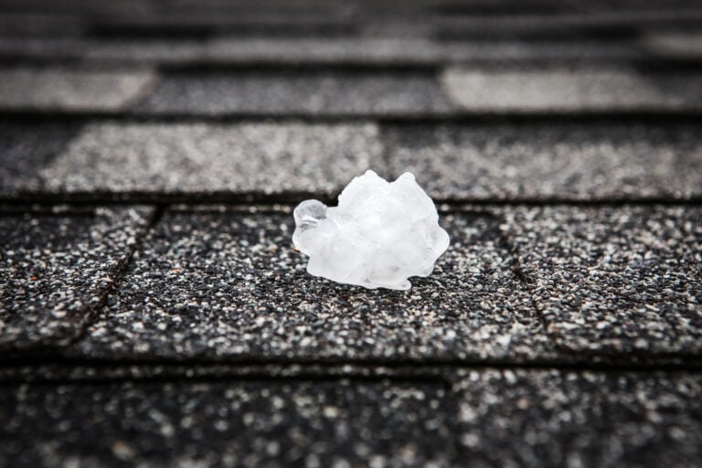 hail damage roof repair ice piece on top of shingles
