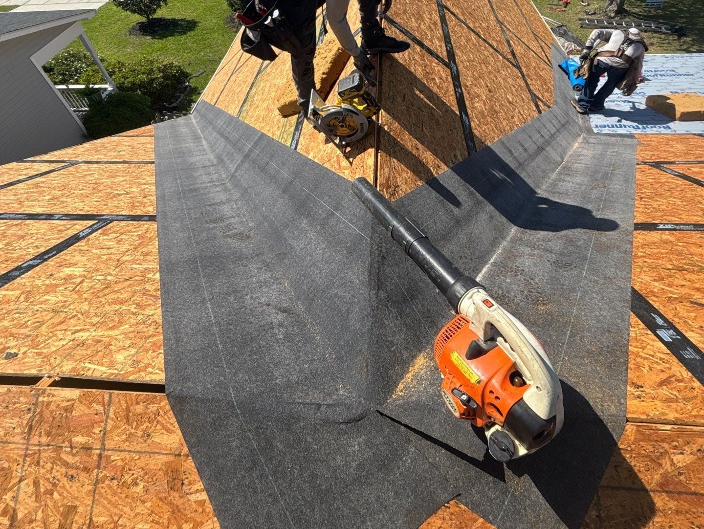 roof flashing repair worker repairing wooden plank