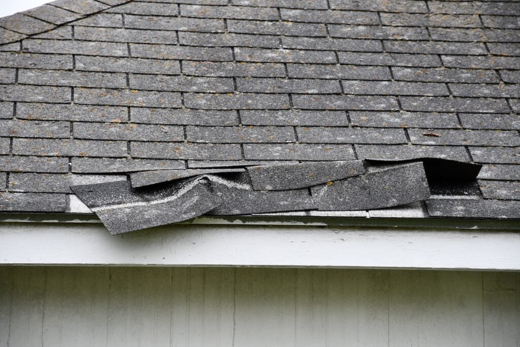 damaged shingles after storm