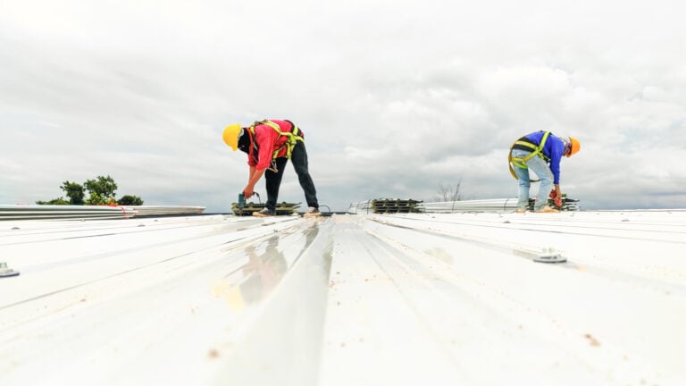 Construction worker install roof, Roofing tools, worke using Electric drill replacement install roof roof plates.